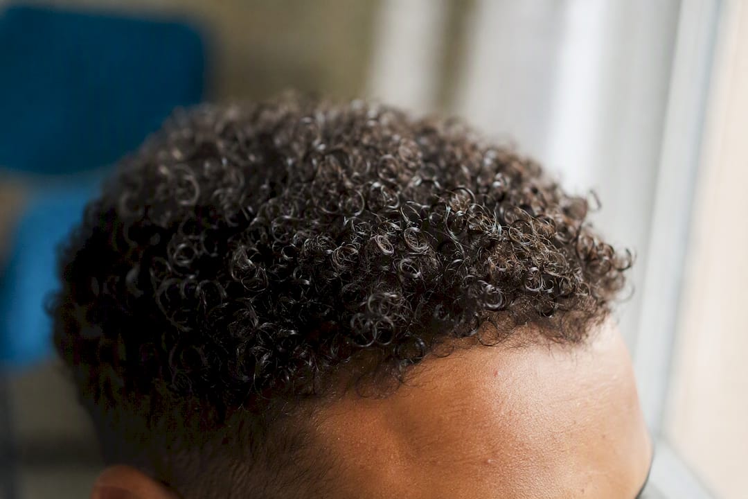 Close-up of curly hair texture over scalp